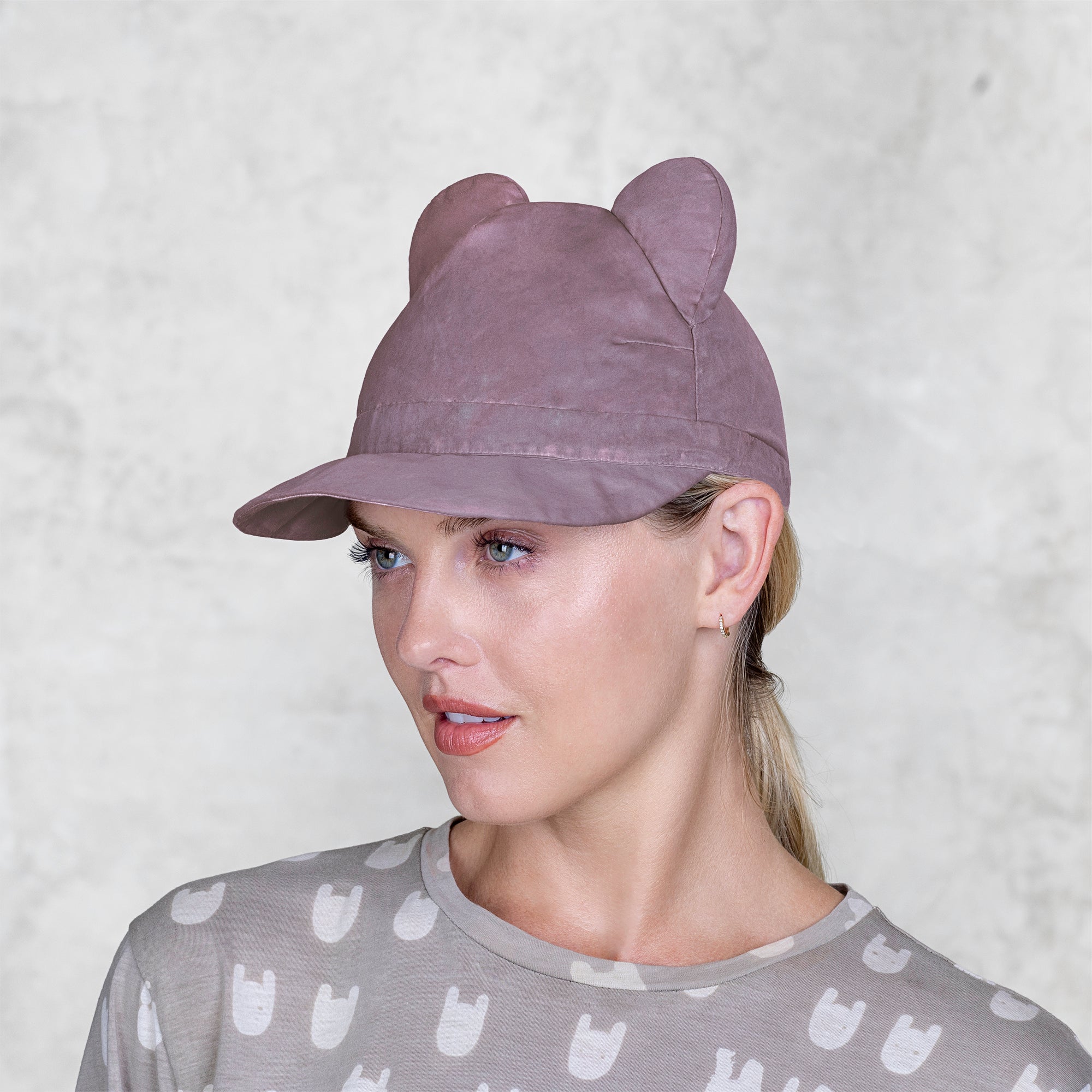 A woman with a BLAMO pink silk cap with ears