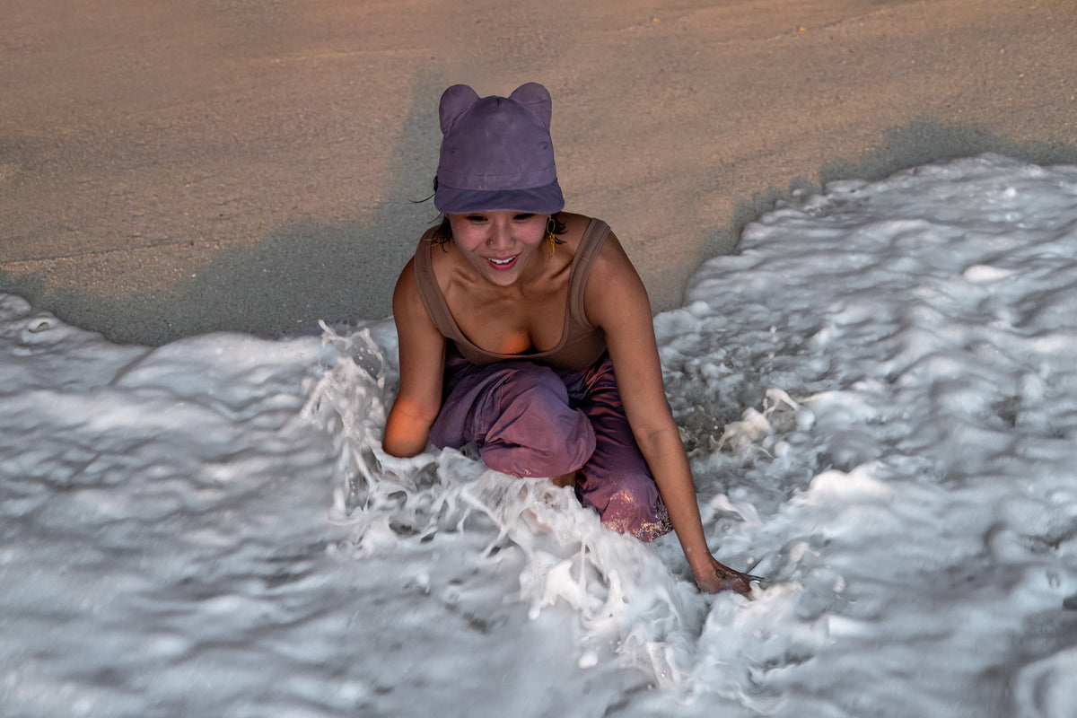 A woman with a BLAMO pink silk cap with ears