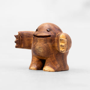 Small wooden sculpture with arms extended in a HUG position and smoky quartz gem eyes