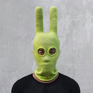 A man wearing an arctic lime green balaclava with horns