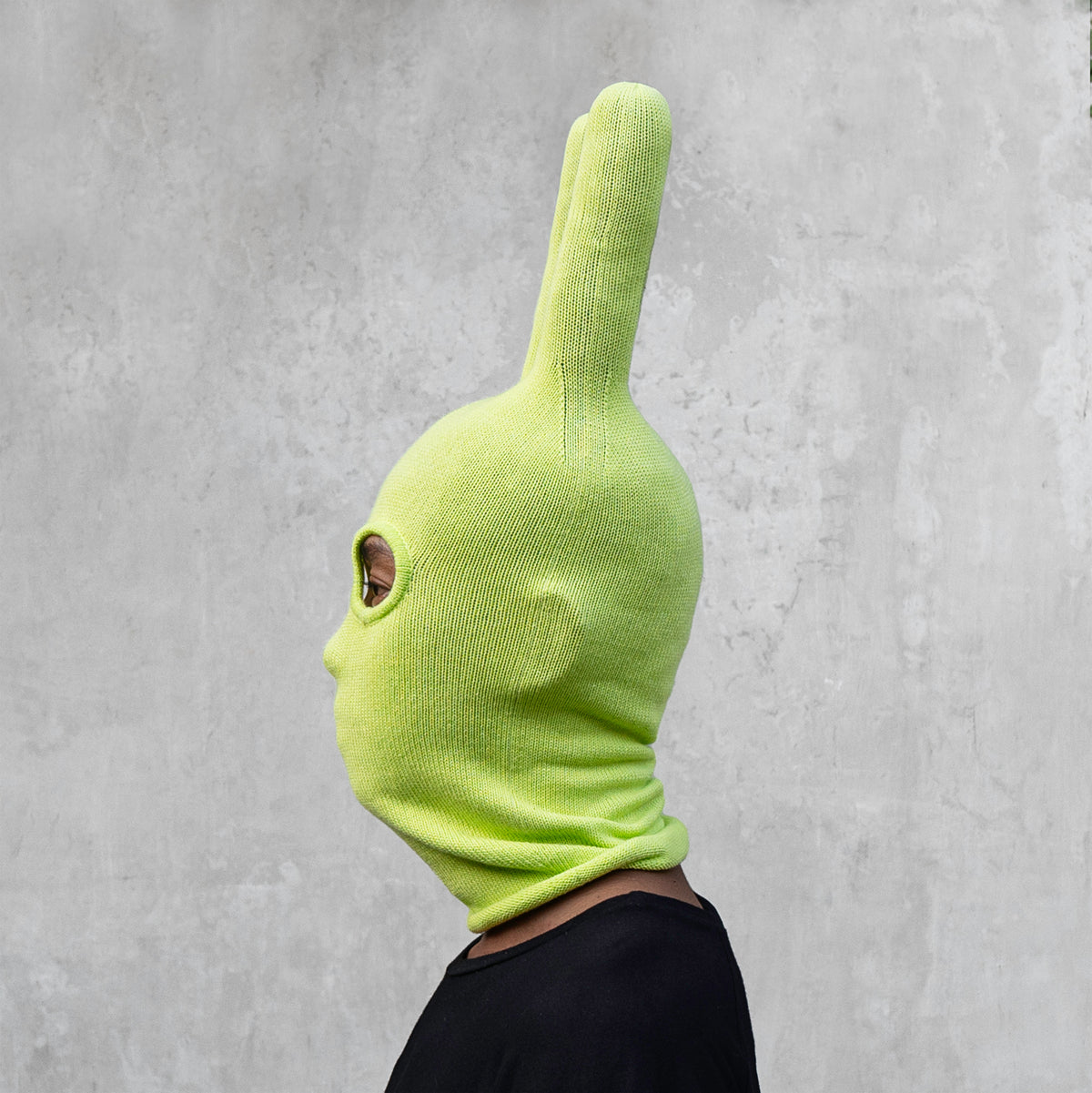 A man wearing an arctic lime green balaclava with horns