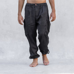 A man wearing a pair of cargo style linen BLAMO linen pants standing from the waist down facing front. 