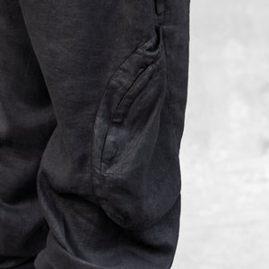 A detail of a bellowed thigh pocket on a pair of BLAMO linen pants 
