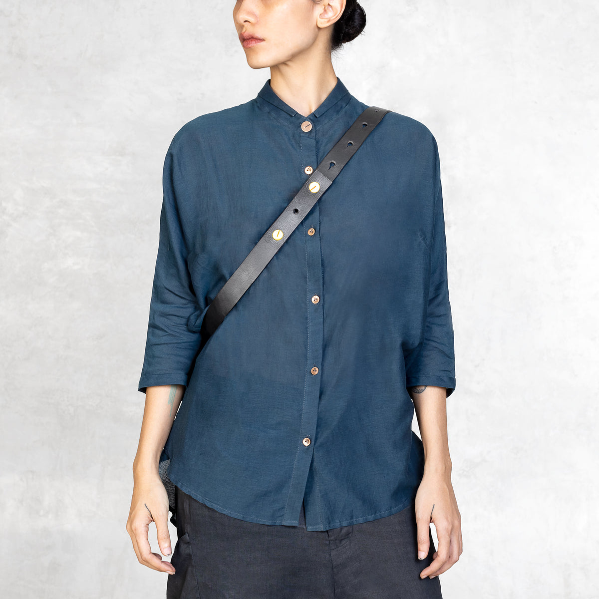 Leather Strap of a waxed canvas Cross Body Bag worn on a woman 