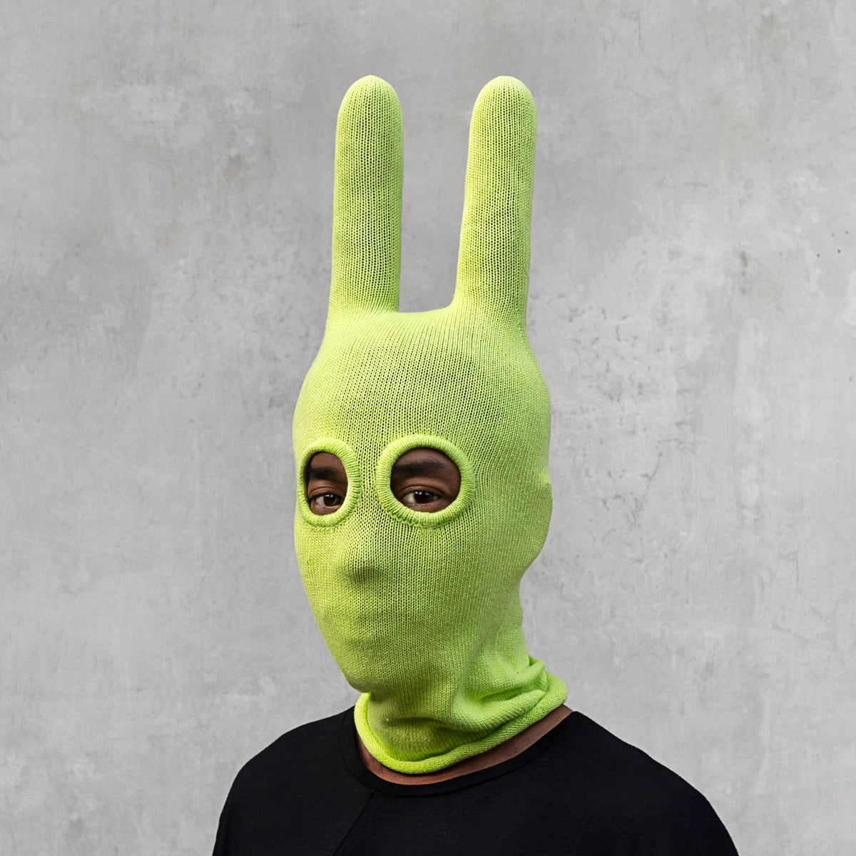 A man wearing an arctic lime green balaclava with horns