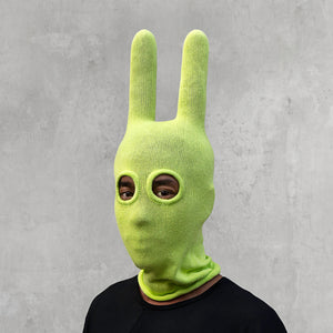 A man wearing an arctic lime green balaclava with horns