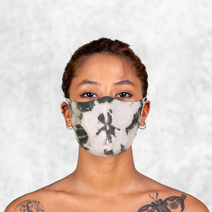 A woman wearing an olive and white Adjustable Tie Dye Face Mask