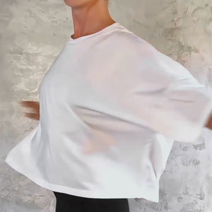 Person in a white cropped t-shirt spinning and moving their arms around