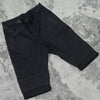 Closeups of details of a pair of black ridged button up belted shorts