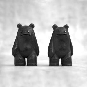 Small black creature figurine shown from different angles