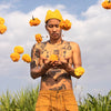 Person making a yellow knit beanie with rounded ears