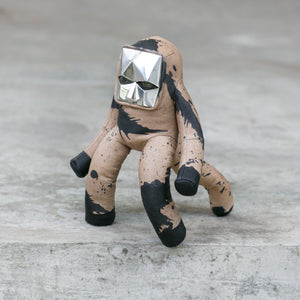 BLAMO Space Baby Splat, a leather toy with a beige and black splattered design and a silver geometric headpiece.