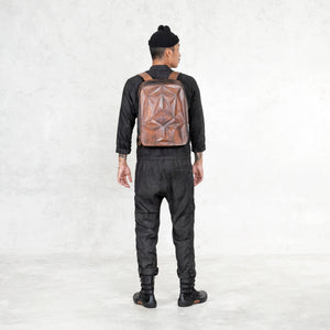 black linen jumpsuit and leather backpack 
