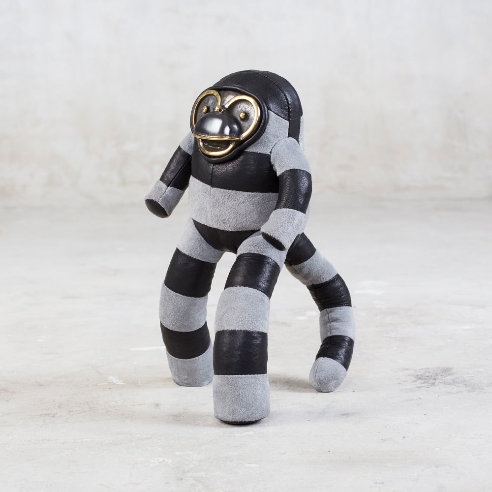 black leather and gray suede designer toy